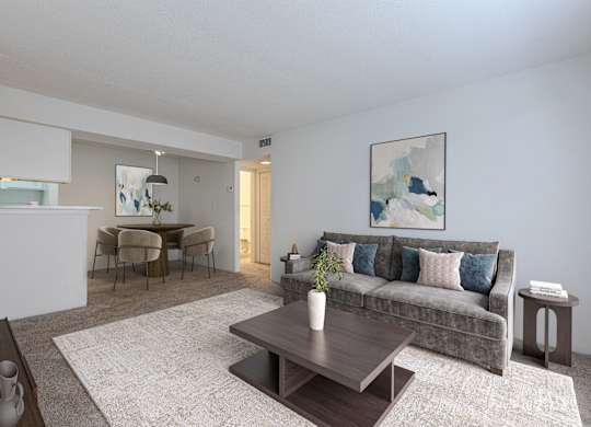 A living room with a grey couch and a coffee table in the middle. at Grove at St. Andrews, Columbia, 29210