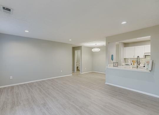 A spacious room with light grey walls and a wooden floor at Keita 1875, College Park, GA 30349