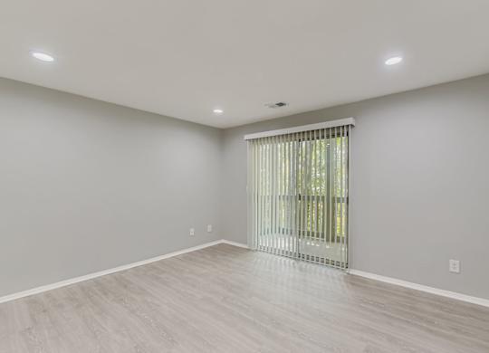 A room with a sliding glass door and light grey walls at Keita 1875, College Park, GA
