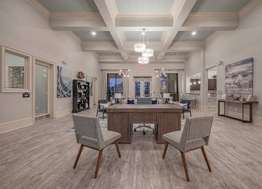 a clubhouse with a large table and chairs in the center of it at Century HomePlace, Prattville