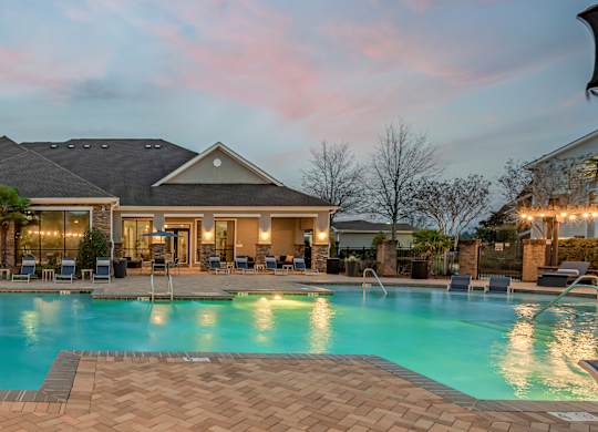 a swimming pool with chairs and a house with a pool at Century HomePlace, Alabama, 36066