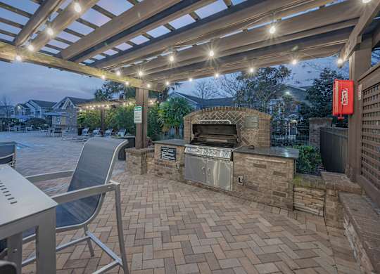 a patio with a grill and a table and chairs at Century HomePlace, Prattville, 36066