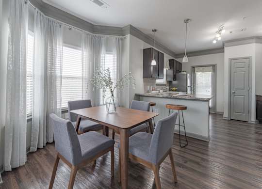 a dining room and kitchen with a table and chairs at Century HomePlace, Alabama