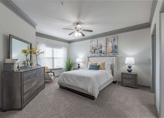 a bedroom with a bed and a ceiling fan at Century HomePlace, Prattville Alabama