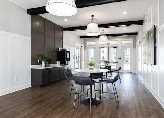 a dining room and kitchen with a table and chairs