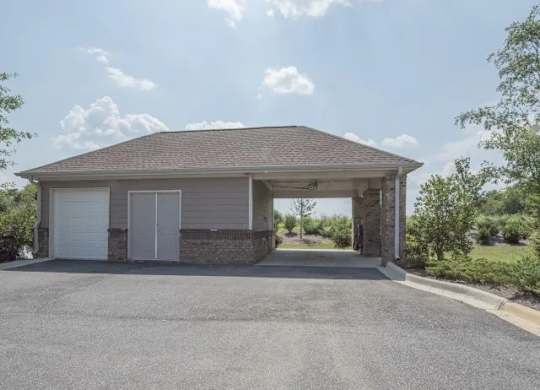 a garage with a roof and a driveway at Century HomePlace, Prattville, 36066