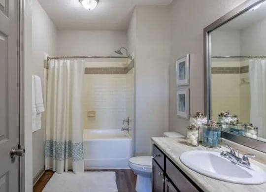 a bathroom with a shower and a sink and a toilet at Century HomePlace, Prattville, AL 36066