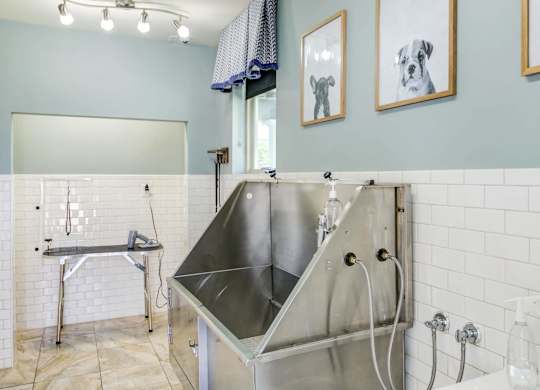 a large stainless steel sink in a bathroom with a shower at Century HomePlace, Prattville Alabama
