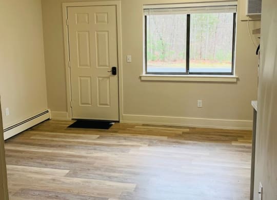 an empty living room with wood floors and a window at Briarcliff at Quechee, Vermont, 05059