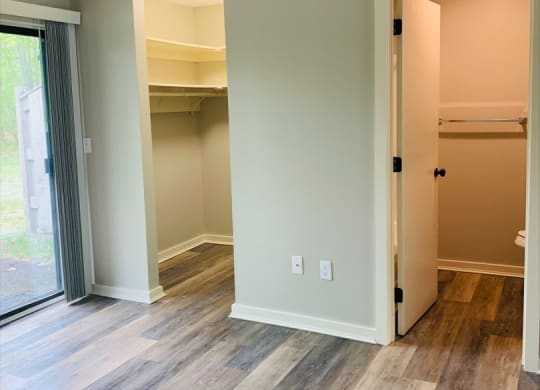 a bedroom with a closet and a sliding glass door at Briarcliff at Quechee, Quechee, VT