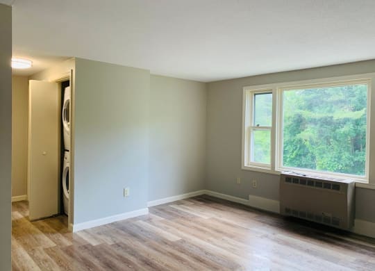 an empty living room with a wood floor and a window at Briarcliff at Quechee, Quechee