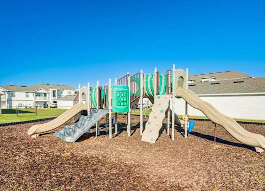 A playground with a green slide and a brown slide.at Century Ariva, Lakeland, 33812