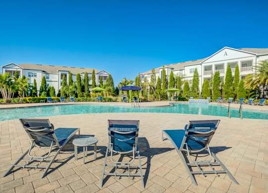 A pool surrounded by chairs and trees with a building in the background.at Century Ariva, Florida, 33812