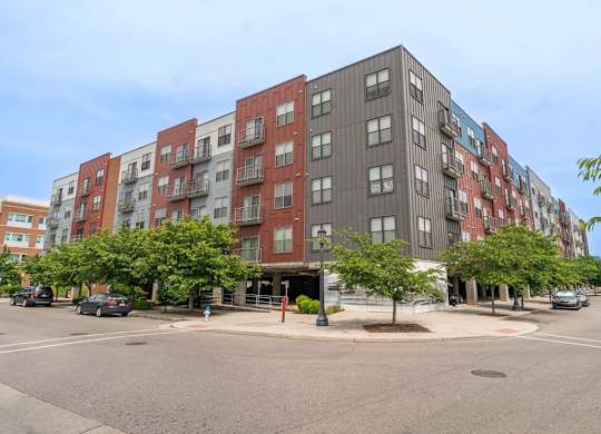 A large multi-story apartment building with a parking lot in front.at Century Bridges, Virginia, 24016