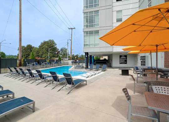 A pool area with sun loungers and umbrellas.at Century Bridges, Roanoke Virginia