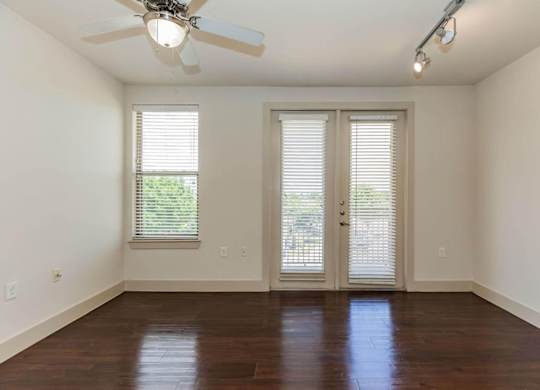 A room with a ceiling fan and sliding glass doors.at Century Cedar Hill, Cedar Hill, TX 75104