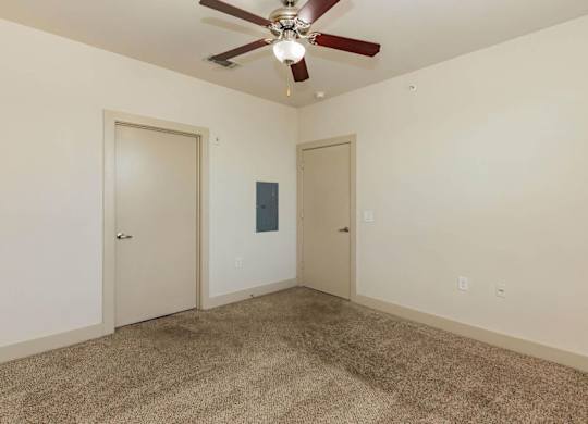 A room with a ceiling fan and carpeted floor.at Century Cedar Hill, Texas, 75104