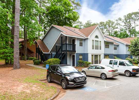 Multi unit residential building with designated parking spaces at Salem Glen Apartments, Conyers