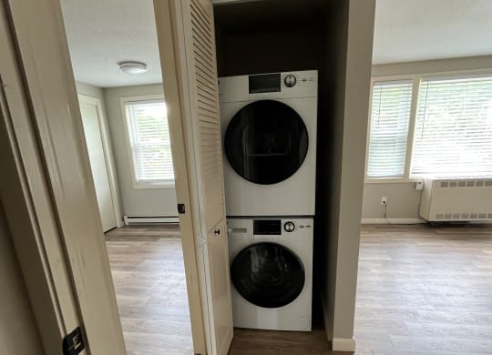 a front loading washer and dryer in a hallway of a home at Briarcliff at Quechee, Quechee