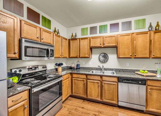 A kitchen with wooden cabinets and stainless steel appliances.