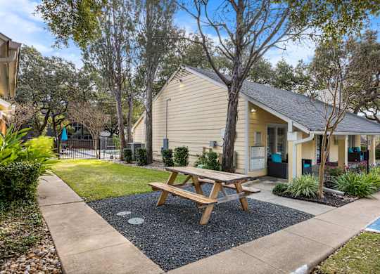 A small house with a picnic table in front.