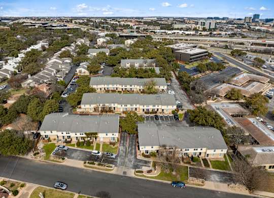 A large building complex with a parking lot in front.