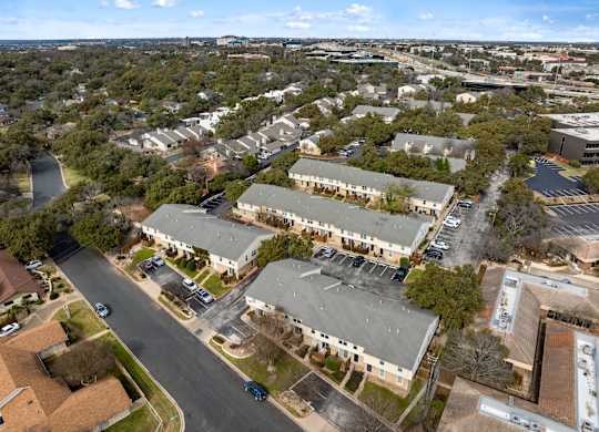 A road runs through a residential area with houses on either side.