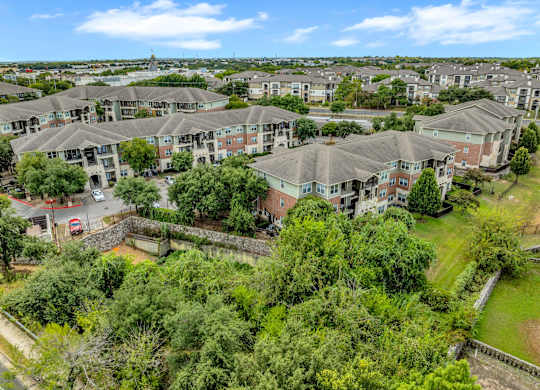A bird's eye view of a residential area with houses and greenery.