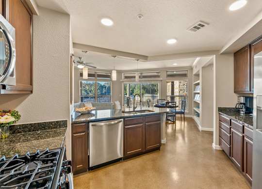 A modern kitchen with a large island and stainless steel appliances. at Bridge at Heritage Woods, Texas