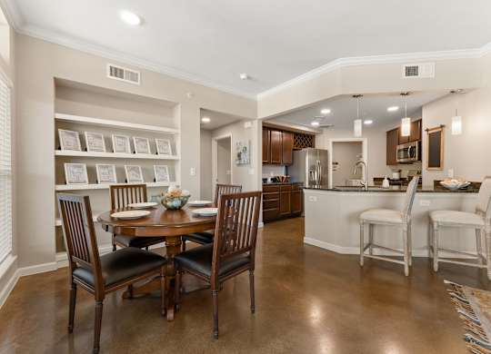 A dining room with a table set for four. at Bridge at Heritage Woods, Austin, 78753