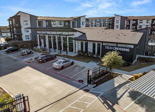 A parking lot in front of a building with the sign at Bridge at Tech Crossing, Texas, 78753