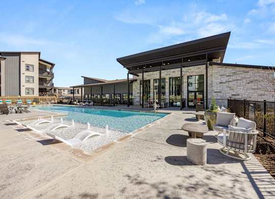 A modern building with a pool in front. at Bridge at Tech Crossing, Austin, Texas