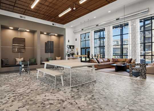 A modern living room with a wooden ceiling and a large window. at Bridge at Tech Crossing, Austin, TX