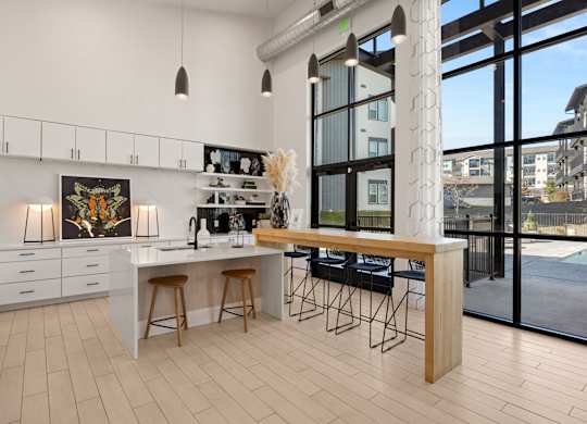 A kitchen with a white countertop and a fridge. at Bridge at Tech Crossing, Austin, 78753