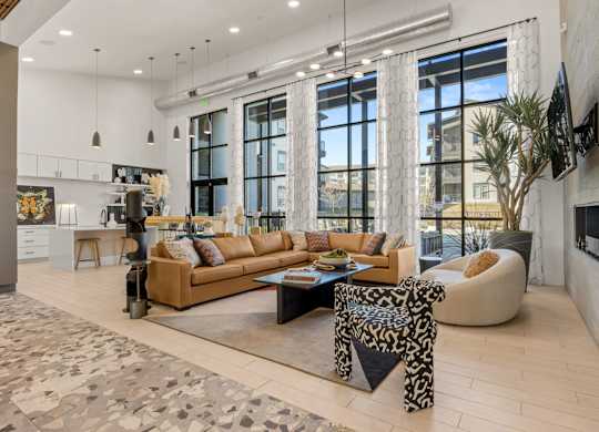 A modern living room with a large sectional sofa and a coffee table. at Bridge at Tech Crossing, Texas
