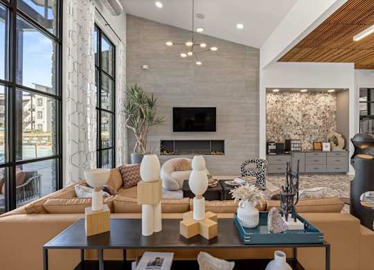 A modern living room with a fireplace and a large window. at Bridge at Tech Crossing, Austin, 78753