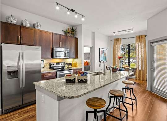 A kitchen with a refrigerator, microwave, oven, and sink. at The Royce at 8100, Texas, 78729
