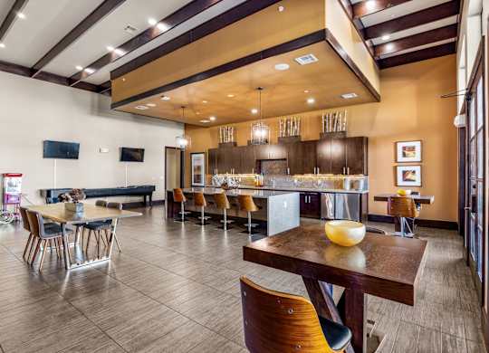 A modern dining room with a wooden table and chairs. at The Royce at 8100, Texas