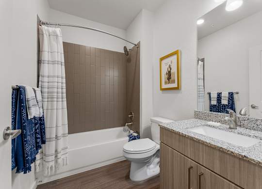 A bathroom with a toilet, sink, and shower.