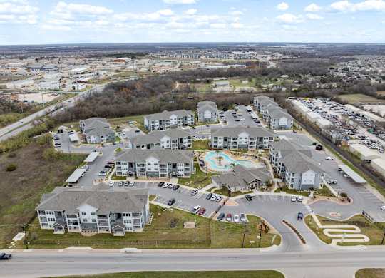 A large residential complex with a swimming pool and a roundabout.