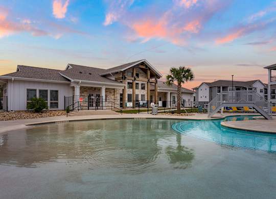 A large house with a pool in front of it.