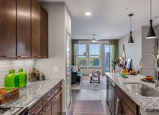 A kitchen with a large island and a window overlooking the living room. at Bridge at Henley, Austin, Texas