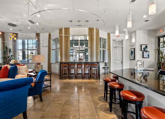 A bar area with blue chairs and a counter. at Bridge at Indigo, Austin, Texas