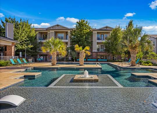 A pool with a fountain in the middle of it. at Bridge at Southpark Meadows, Austin, TX, 78748