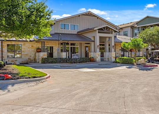 A large building with a parking lot in front. at Bridge at Southpark Meadows, Austin