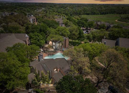 A house with a pool surrounded by trees. at Montecito, Texas, 78741