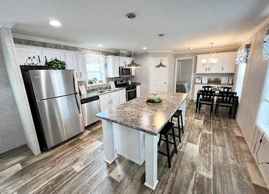 a kitchen with a large island and stainless steel appliances