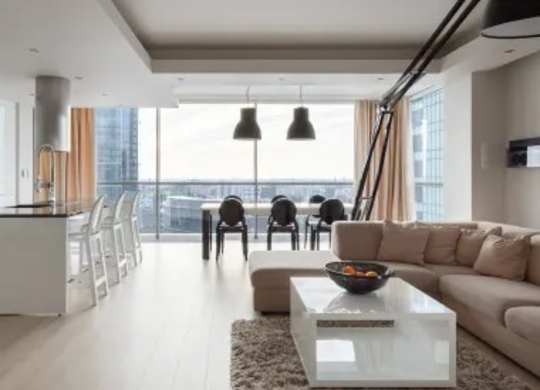 A modern living room with a large window overlooking the city.