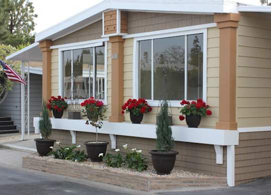a house with red flowers in front of it