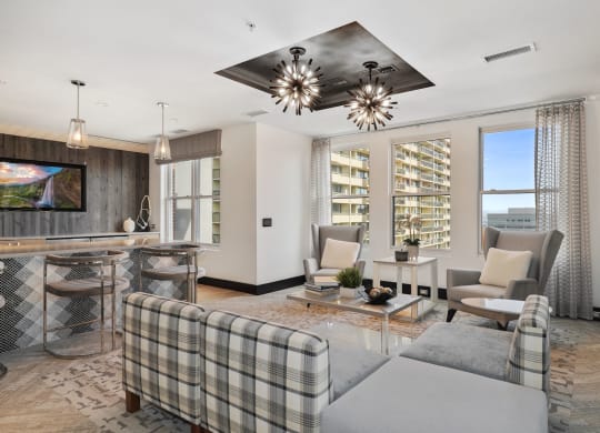A modern living room with a grey plaid couch and a wooden coffee table.